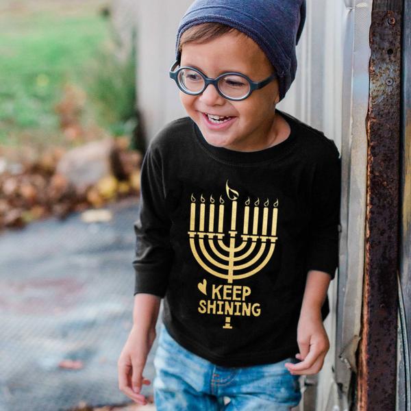 Cool Hanukkah gifts for kids: Keep shining Menorah shirt from Free to Be Kids