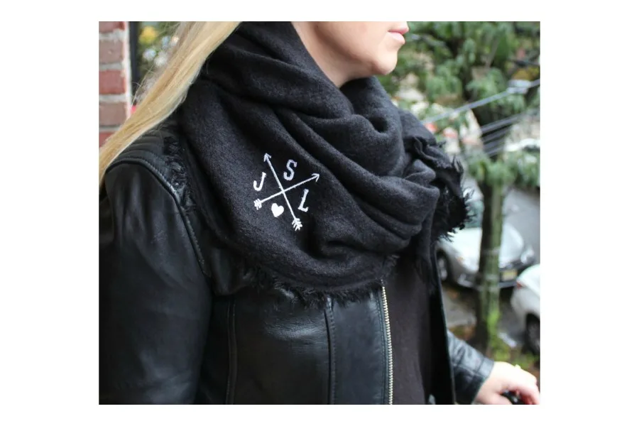 This monogrammed blanket scarf by Rosa Gold is one of writer Delilah's top holiday picks this season.
