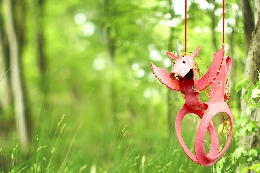 Cool backyard swings for kid: Pink Unicorn recycled tire swing
