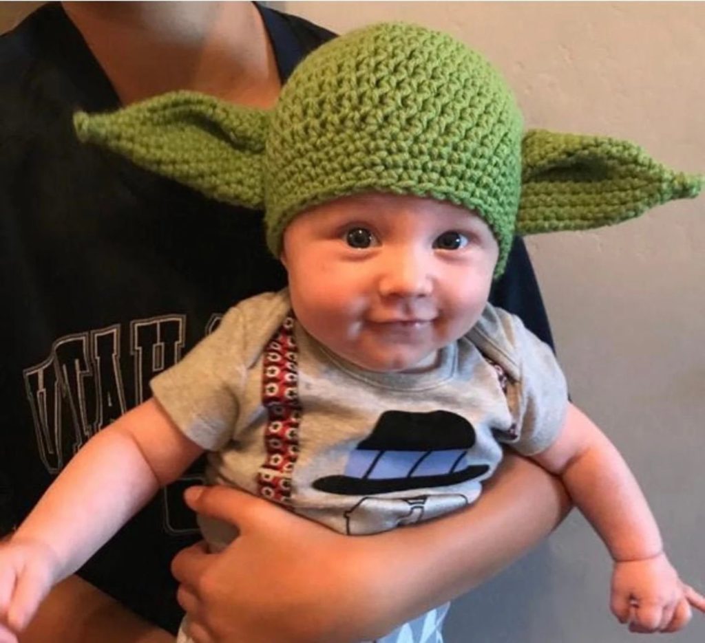 This baby Yoda knit hat from Lyons Happy Hats is perfect for a Star Wars themed baby wearing costume