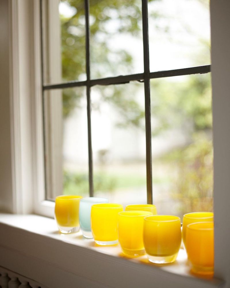 How to decorate with tea lights: line colorful votives up along a window sill, like these from glassybaby