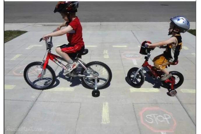 Creating a bike chalk road to teach bike safety right in your driveway | via Melissa & Doug