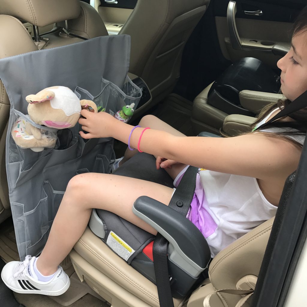 Road trip travel tips for families: Use a hanging shoe bag over the seat to keep kids organized in back and to keep your eyes on the road | © Kristen Chase for coolmompicks.com