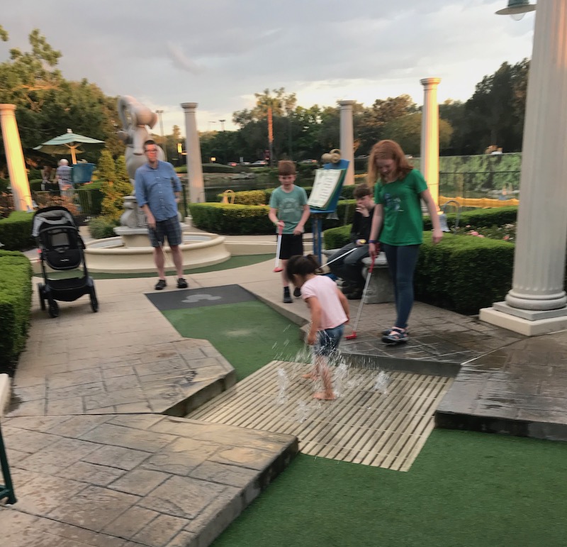 Disney World with kids with special needs: Pack extra clothes for stress-free moments of unplanned fun, like smashing in the water on the putt putt course! | (c) Kate Etue for Cool Mom Picks