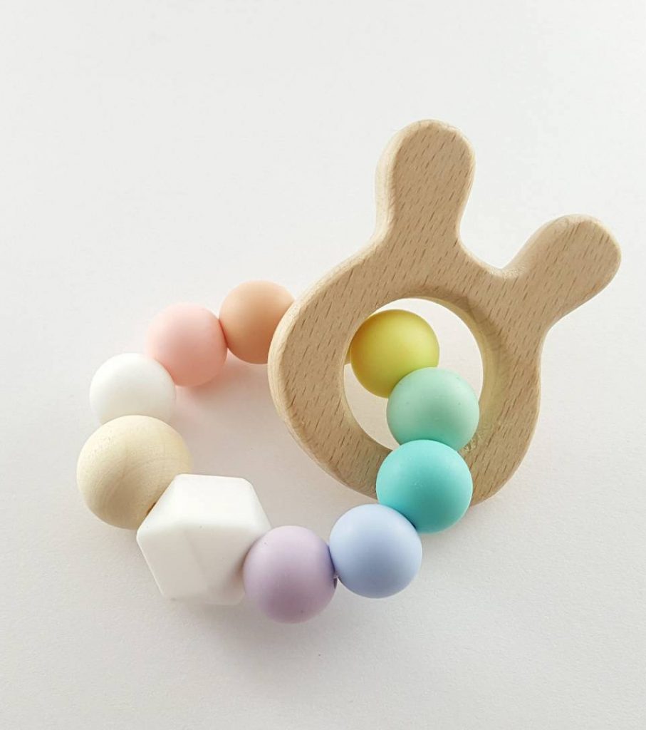 Cute Easter gifts for babies: Handmade wooden rabbit and pastel teether toy from I Got Chew on Etsy