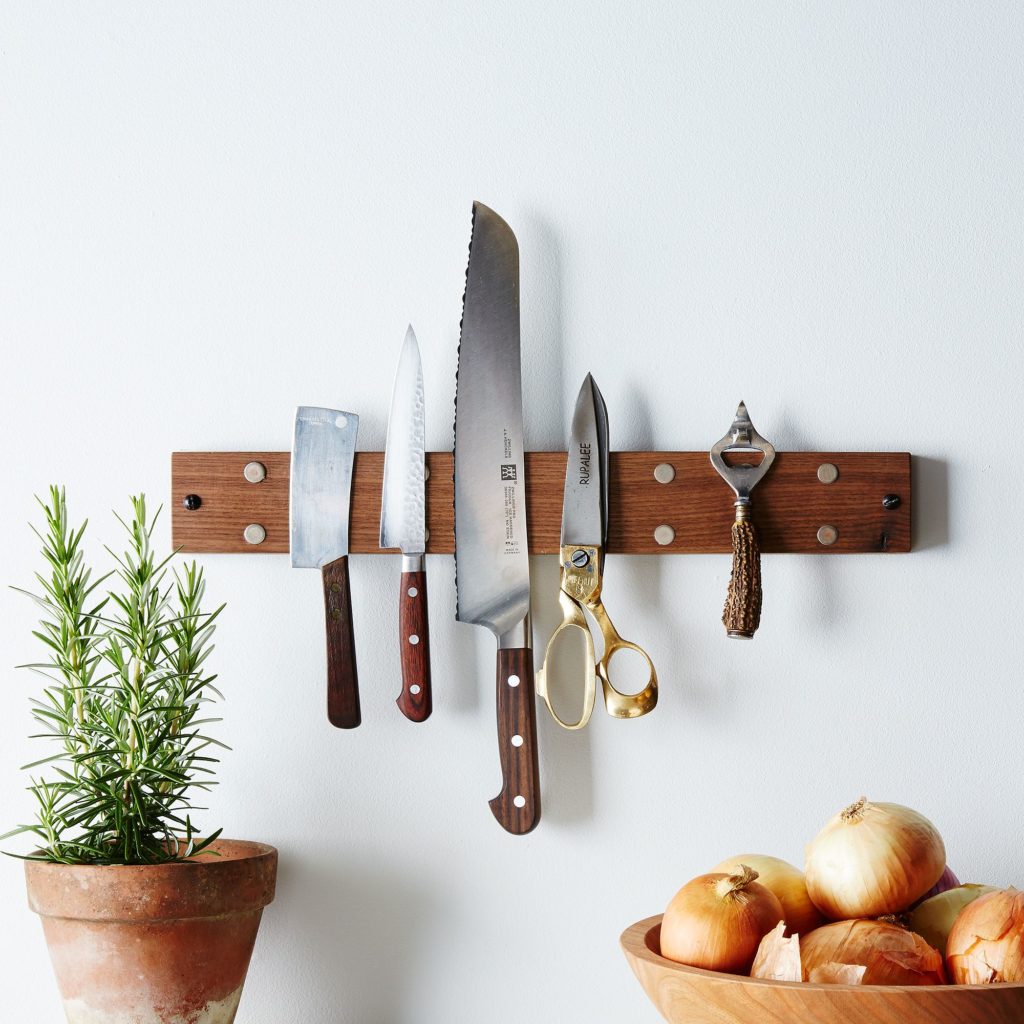 Decluttering solutions for small spaces: Hang your knives, also keeping them from dulling and gathering bacteria. |. Reclaimed wood rack from Food52