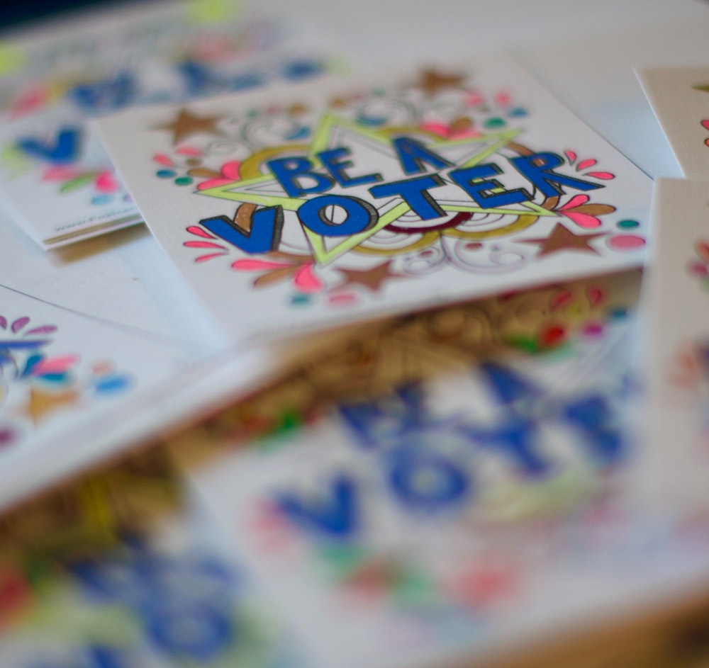 Teens who are too young to vote and color or write postcards to voters