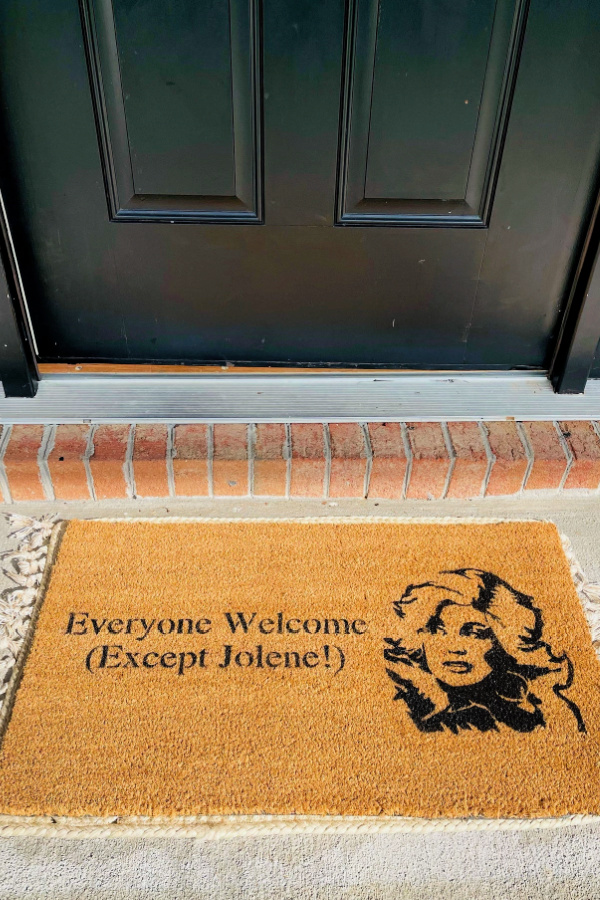 Gifts for Dolly Parton fans: "Anyone but Jolene" welcome mat from Designs Beyond Borders