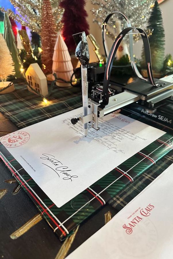 "Personalized" letters from Santa's Magic Mailroom to your children are composed with this unique handwriting printer, all for a donation to Girls Who Code