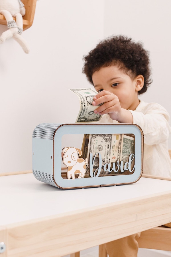 Teaching kids about money with a personalized piggy bank from 2BWoodKids on Etsy